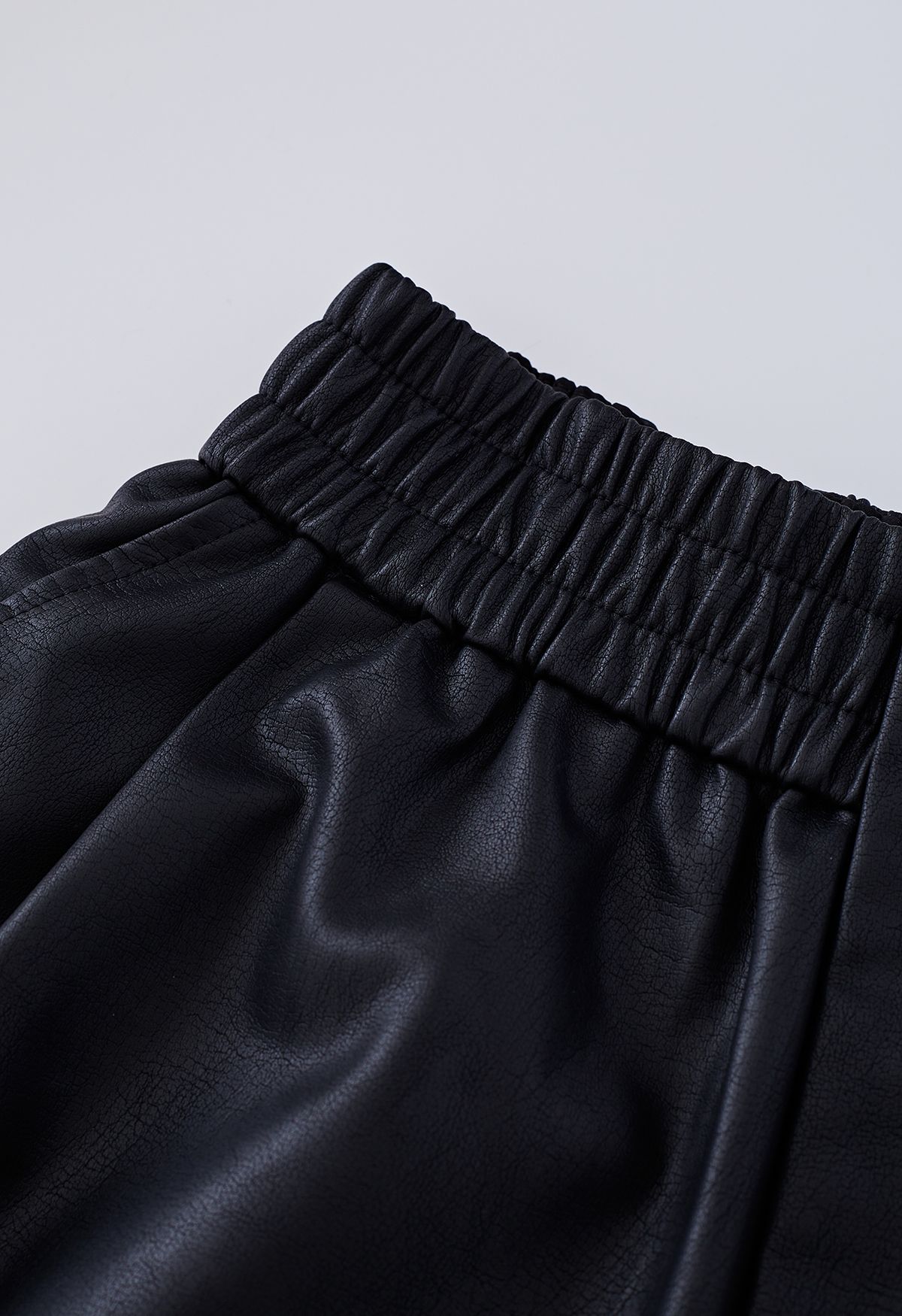 Textured Buttoned Faux Leather Shorts in Black